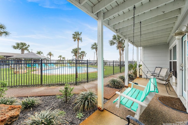 71 W Nassau Unit 302, Rockport, TX 78382 - view of patio with fence and a community pool