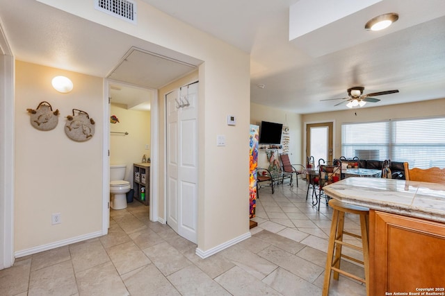 71 W Nassau Unit 302, Rockport, TX 78382 - kitchen featuring ceiling fan, light tile patterned floors, visible vents, light countertops, and baseboards