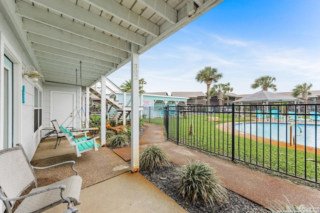 71 W Nassau Unit 302, Rockport, TX 78382 - view of patio / terrace featuring fence, a community pool, and stairway