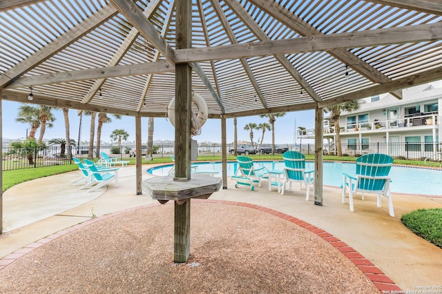 71 W Nassau Unit 302, Rockport, TX 78382 - view of patio featuring a pergola, a community pool, and fence