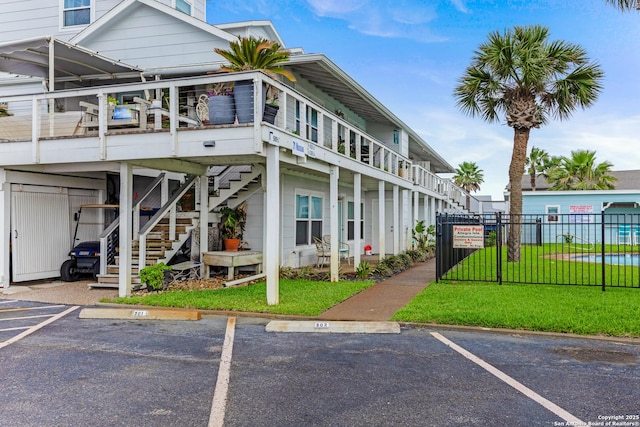 71 W Nassau Unit 302, Rockport, TX 78382 - exterior space featuring uncovered parking, a lawn, fence, and stairs