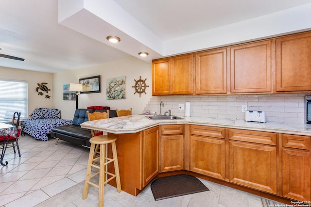 71 W Nassau Unit 302, Rockport, TX 78382 - kitchen featuring open floor plan, brown cabinets, a sink, and backsplash