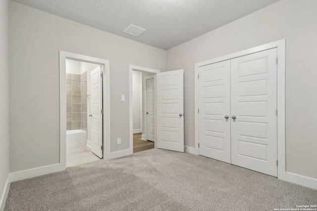 17110 Autry Fls, San Antonio, TX 78247 - unfurnished bedroom with carpet flooring, a closet, ensuite bathroom, and a textured ceiling