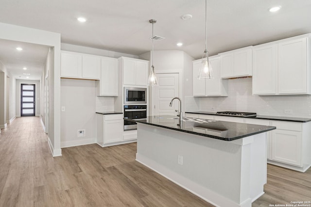 17114 Autry Fls, San Antonio, TX 78247 - kitchen with stainless steel appliances, dark countertops, light wood-style flooring, tasteful backsplash, and white cabinets