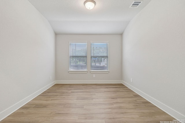 17114 Autry Fls, San Antonio, TX 78247 - empty room with light wood-style floors and vaulted ceiling