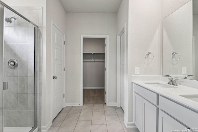 11534 Cottage Pt, San Antonio, TX 78254 - bathroom with a shower stall, double vanity, a walk in closet, and tile patterned floors
