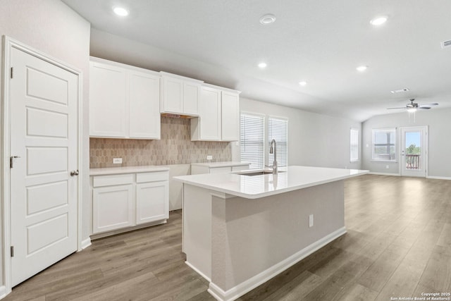 11538 Cottage Pt, San Antonio, TX 78254 - kitchen featuring light wood-style flooring, tasteful backsplash, white cabinets, and recessed lighting