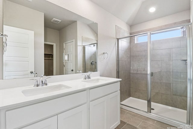 11538 Cottage Pt, San Antonio, TX 78254 - bathroom featuring a stall shower, double vanity, tile patterned floors, a walk in closet, and vaulted ceiling