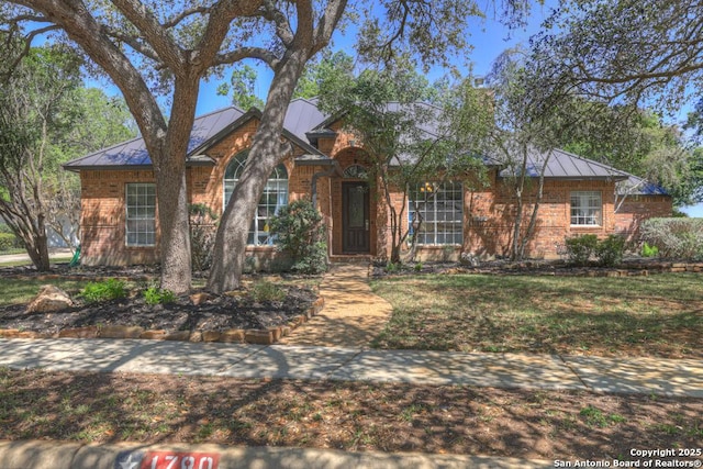1780 Oak Frst, New Braunfels, TX 78132 - view of front of house featuring a standing seam roof, metal roof, and brick siding