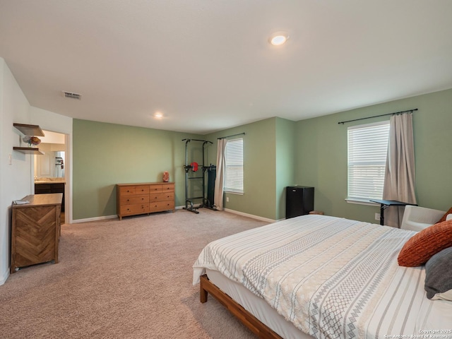 bedroom featuring visible vents, baseboards, recessed lighting, and light carpet