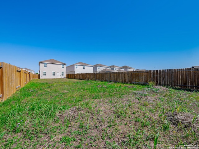 view of yard with a fenced backyard