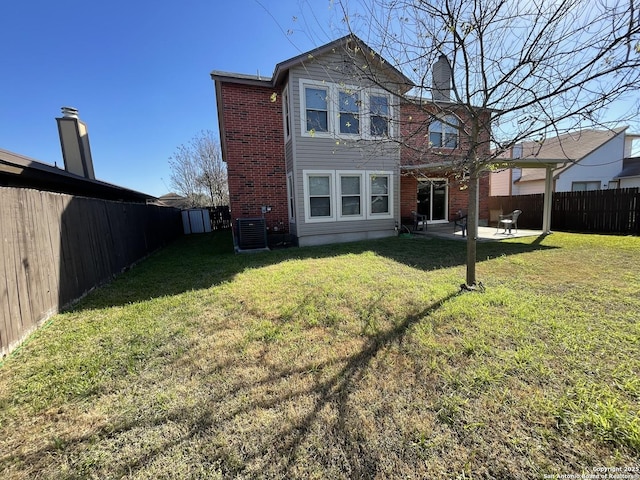 rear view of house featuring a patio area, central air condition unit, a fenced backyard, and a lawn