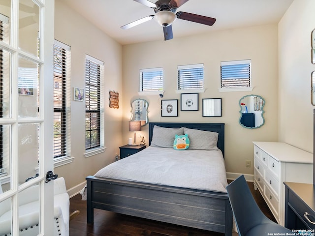 bedroom with dark wood-style flooring, baseboards, and a ceiling fan