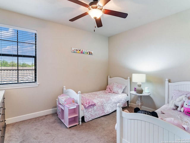 carpeted bedroom featuring ceiling fan and baseboards