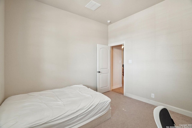 bedroom featuring visible vents, baseboards, and light carpet