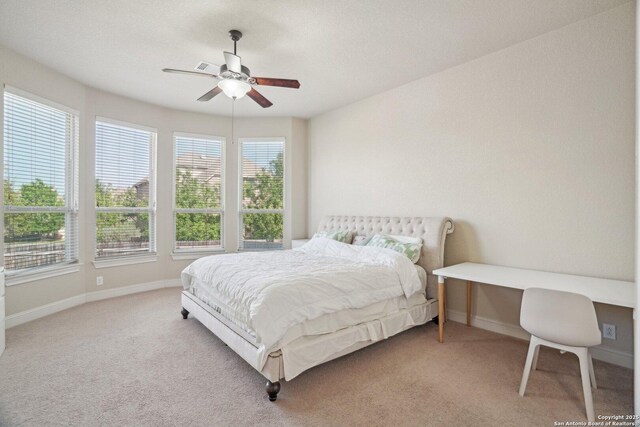carpeted bedroom featuring baseboards and ceiling fan