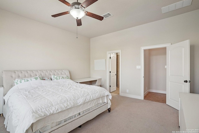 carpeted bedroom with ceiling fan, baseboards, and visible vents
