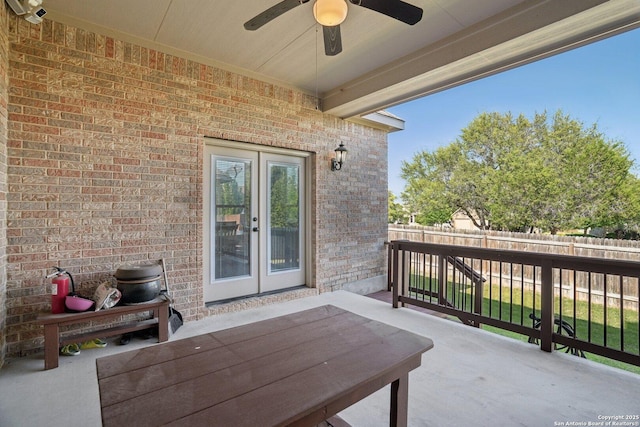 view of patio with fence and a ceiling fan