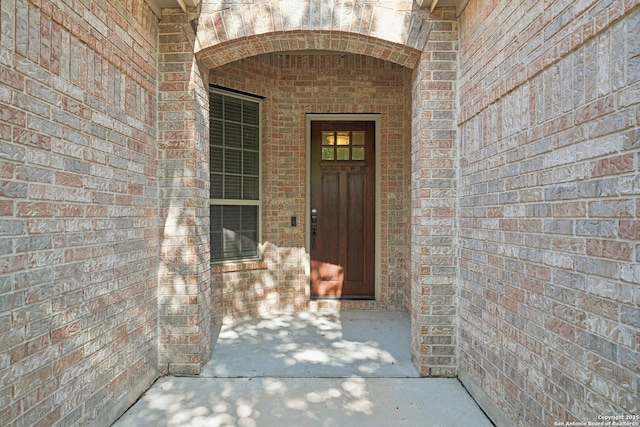 entrance to property with brick siding and stone siding