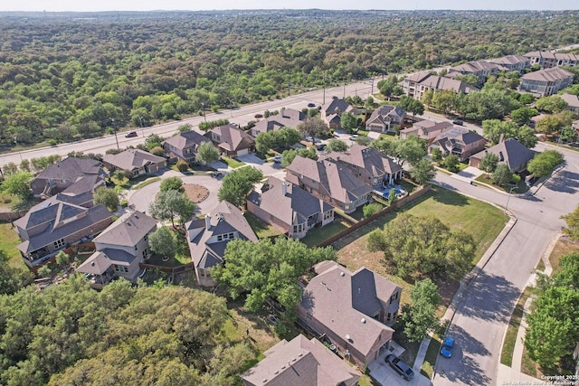 drone / aerial view with a residential view and a view of trees