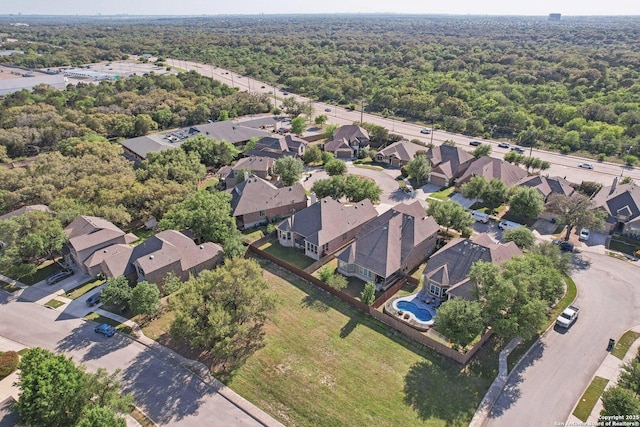 bird's eye view with a wooded view and a residential view