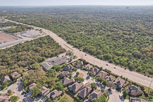birds eye view of property with a forest view and a residential view