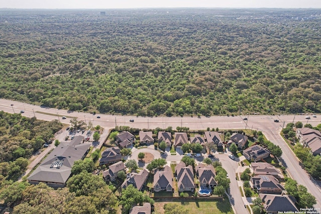 aerial view featuring a forest view and a residential view