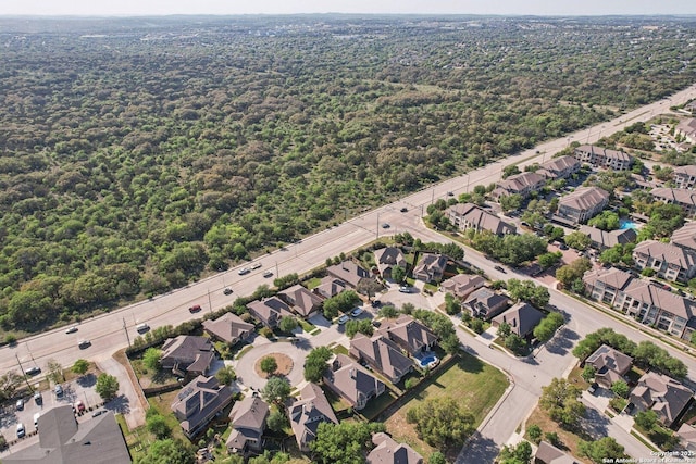 drone / aerial view with a forest view and a residential view