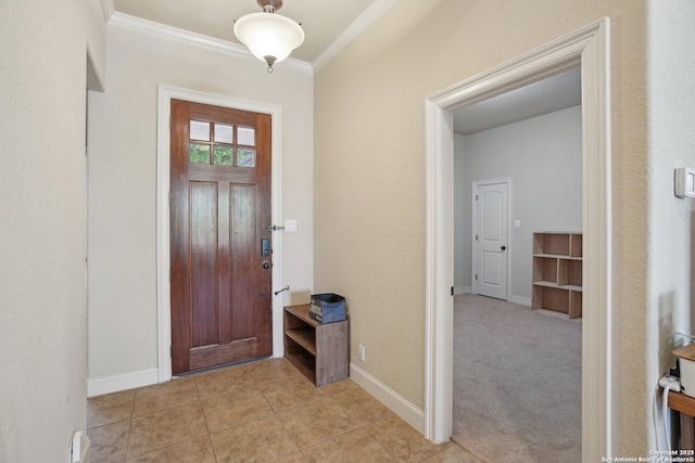 foyer featuring light tile patterned floors, baseboards, and ornamental molding