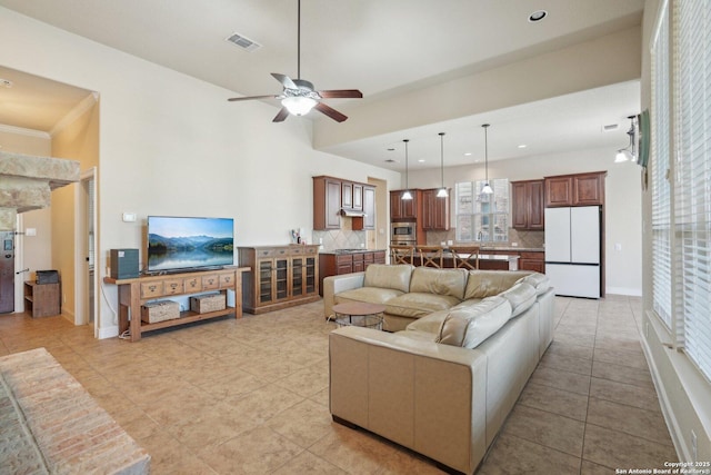 living area featuring light tile patterned floors, ceiling fan, recessed lighting, and visible vents