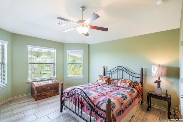 bedroom with visible vents, baseboards, ceiling fan, and wood finish floors