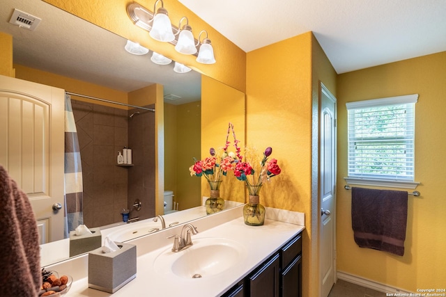 full bathroom featuring vanity, tile patterned flooring, visible vents, toilet, and curtained shower