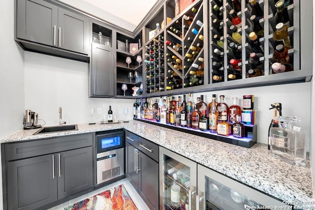 bar with indoor wet bar, wine cooler, and a sink