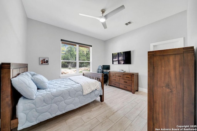bedroom with visible vents, light wood-type flooring, baseboards, and ceiling fan