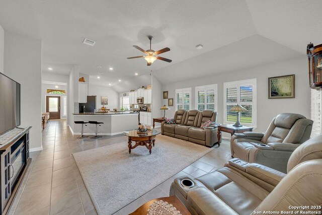 living area featuring ceiling fan, visible vents, recessed lighting, light tile patterned flooring, and lofted ceiling