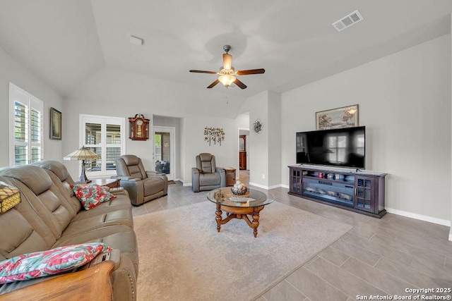 tiled living area with visible vents, baseboards, a ceiling fan, and vaulted ceiling