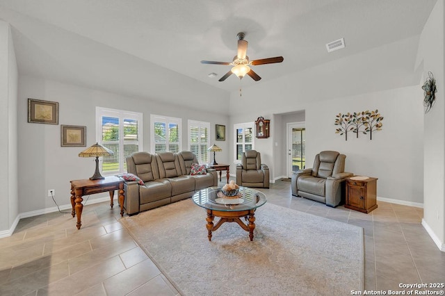 living area with visible vents, baseboards, a ceiling fan, and light tile patterned flooring