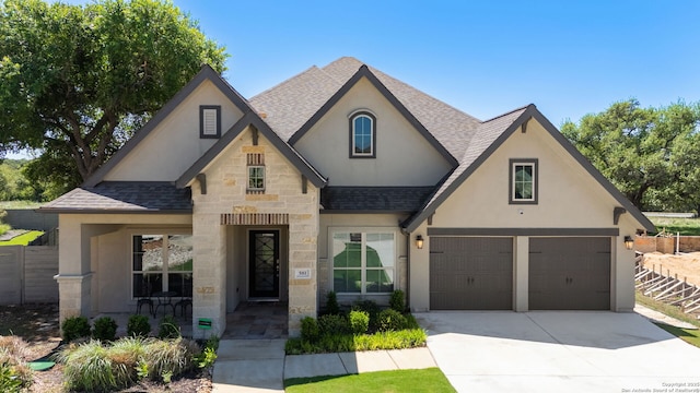 581 Vale Ct, New Braunfels, TX 78132 - view of front facade with a shingled roof, stone siding, driveway, and stucco siding