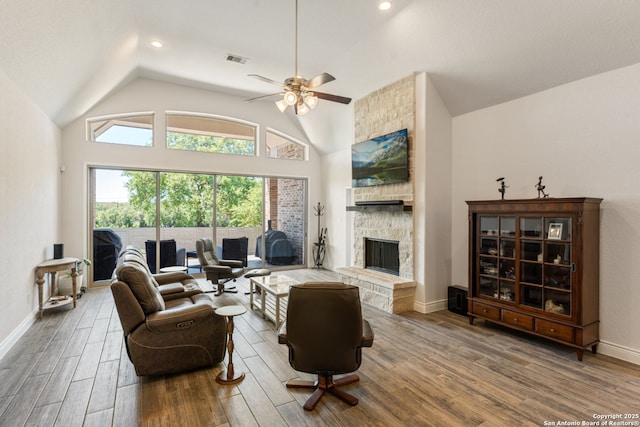 581 Vale Ct, New Braunfels, TX 78132 - living area featuring visible vents, a stone fireplace, wood finished floors, and lofted ceiling
