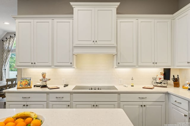 581 Vale Ct, New Braunfels, TX 78132 - kitchen featuring black electric stovetop, light countertops, white cabinetry, and backsplash