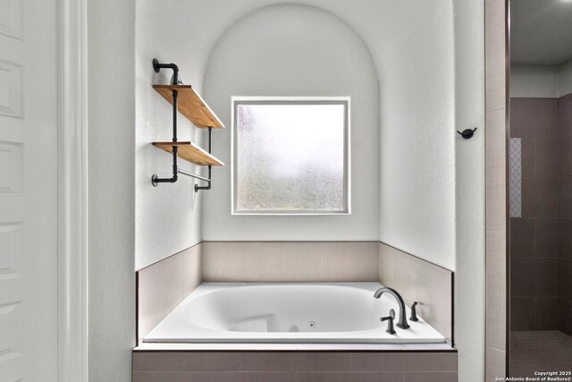 291 Strasbourg, Castroville, TX 78009 - bathroom featuring a jetted tub and tiled shower