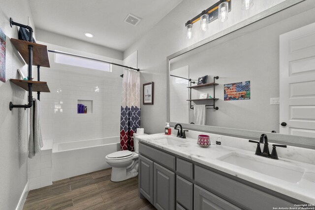 291 Strasbourg, Castroville, TX 78009 - bathroom featuring wood finished floors, toilet, double vanity, shower / bathtub combination with curtain, and recessed lighting