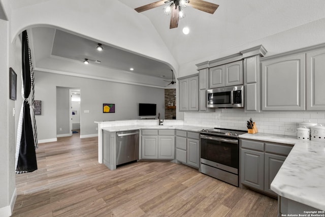 291 Strasbourg, Castroville, TX 78009 - kitchen featuring gray cabinets, stainless steel appliances, a ceiling fan, vaulted ceiling, and arched walkways