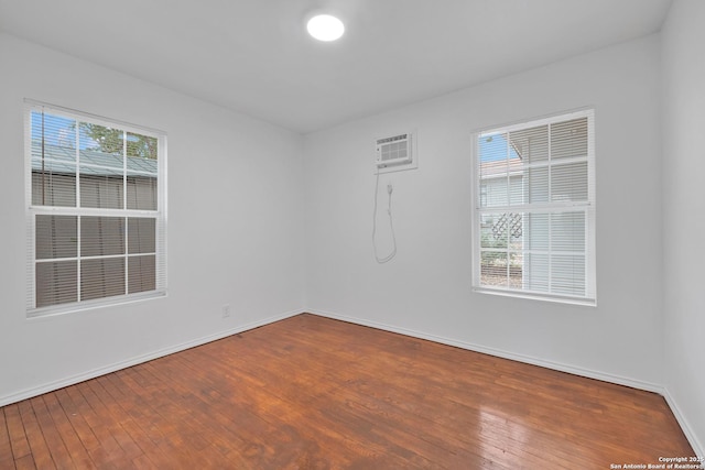 162 Birchwood, San Antonio, TX 78213 - unfurnished room with hardwood / wood-style floors, a wall unit AC, and baseboards
