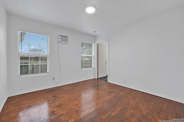 162 Birchwood, San Antonio, TX 78213 - spare room featuring baseboards, hardwood / wood-style flooring, and a wall mounted air conditioner