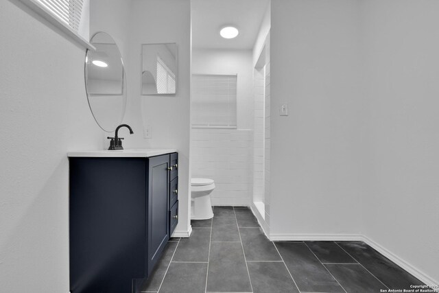 162 Birchwood, San Antonio, TX 78213 - bathroom featuring vanity, baseboards, tile patterned floors, toilet, and a shower