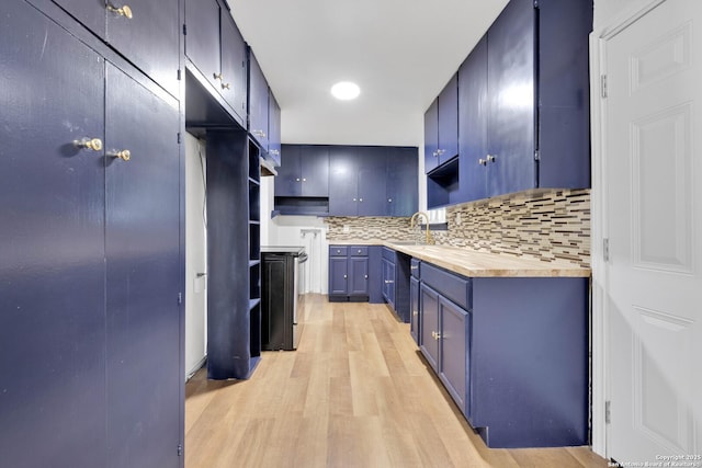 162 Birchwood, San Antonio, TX 78213 - kitchen featuring a sink, light countertops, decorative backsplash, light wood-style flooring, and blue cabinets