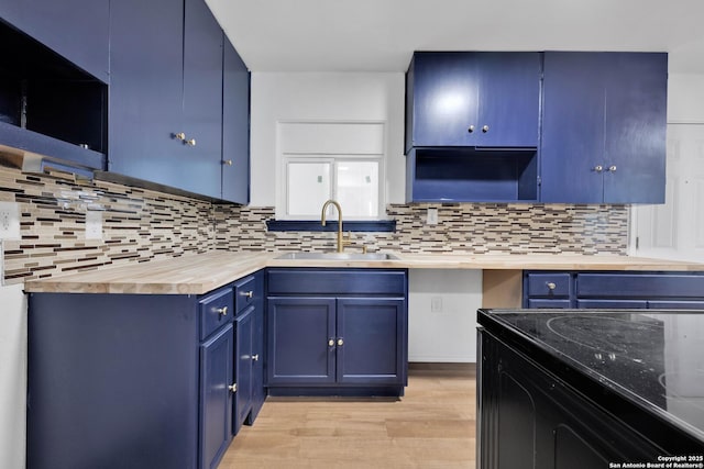 162 Birchwood, San Antonio, TX 78213 - kitchen featuring tasteful backsplash, a sink, and blue cabinets