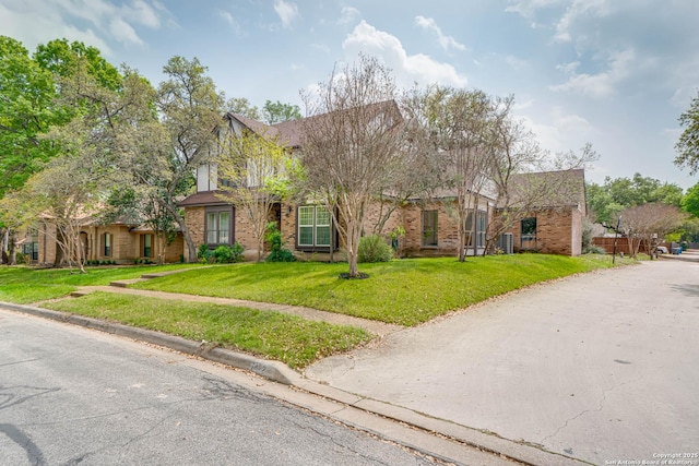 traditional-style house with brick siding and a front lawn