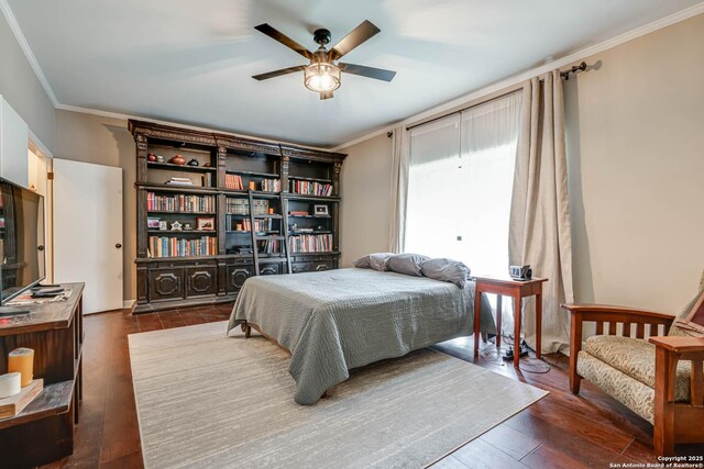 bedroom featuring dark wood-style flooring, ornamental molding, and ceiling fan